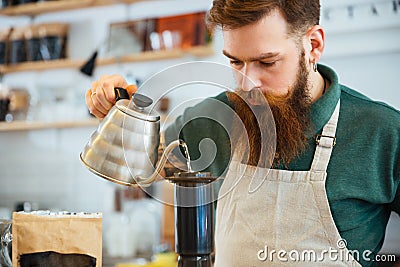 Barista pouring water on coffee ground with filter Stock Photo