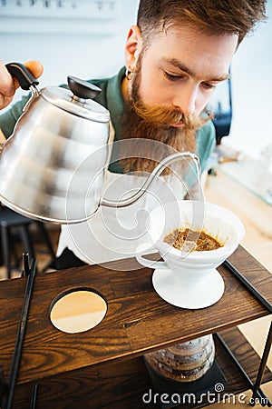 Barista pouring water on coffee ground with filter Stock Photo