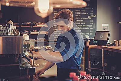 Barista preparing cup of coffee for customer in coffee shop. Stock Photo
