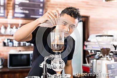 Barista preparing drip coffee in Asian coffee shop Stock Photo