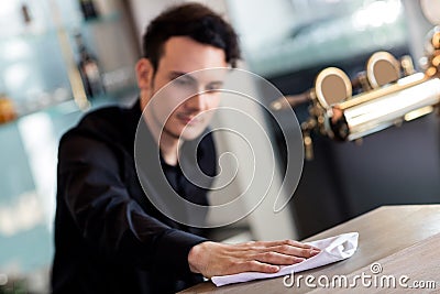 Barkeeper cleaning counter with napkin Stock Photo