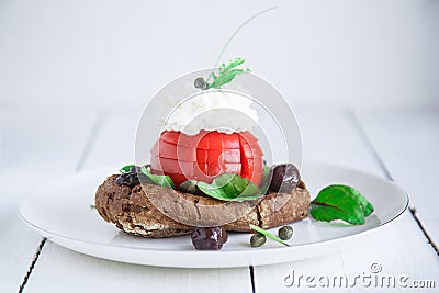 Barley rusk dakos, topped with feta cheese, tomato cubes, olive oil and oregano, Greek appetizer Stock Photo