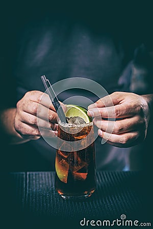 Barman is decorating cocktail Stock Photo