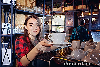 The barman girl works at bar in restaurant Stock Photo