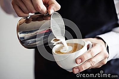 Barman making coffee, pouring milk Stock Photo