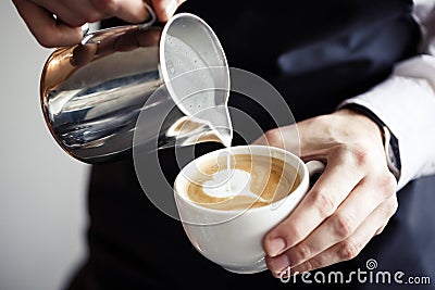 Barman making coffee, pouring milk Stock Photo