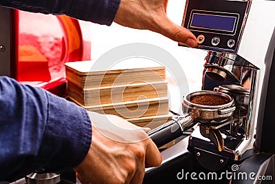 Closeup of barmen hand brewing espresso in professional coffee machine Stock Photo