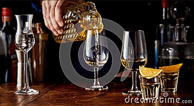 Barman pouring spirits from a cut glass decanter Stock Photo