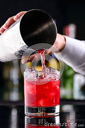 Barman preparing strawberry daiquiri cocktail. Stock Photo