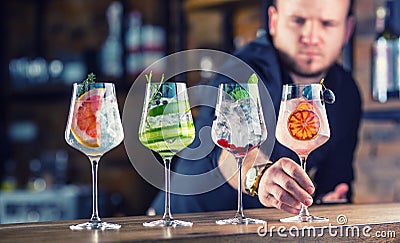 Barman in pub or restaurant preparing a gin tonic cocktail drin Stock Photo