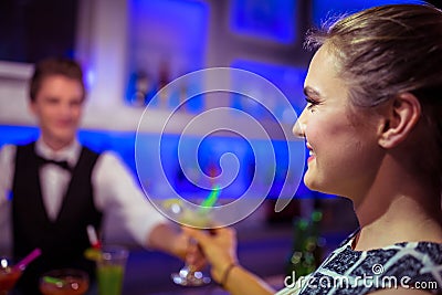 Barman serving cocktail to woman Stock Photo