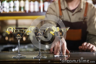 Barman serving glasses of lemon drop martini on counter, closeup. Stock Photo
