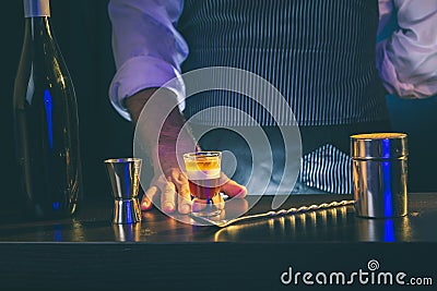 Barman serving B 52 cocktail Stock Photo