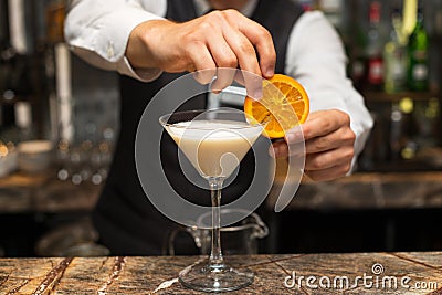 Barman at work, preparing cocktails. pouring pina colada to cocktail glass. Stock Photo