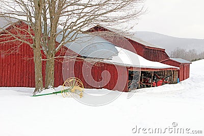 Barn and cultivator in snow, winter Stock Photo