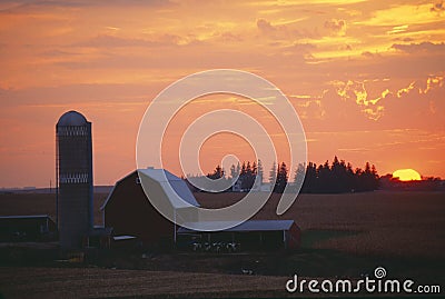 Barn and Silo at sunset Stock Photo