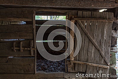 Barn stall in a vintage rough hewn log barn Stock Photo