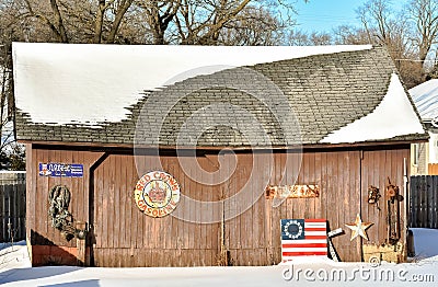 Barn with Vintage Signs and Colonial Flag Editorial Stock Photo