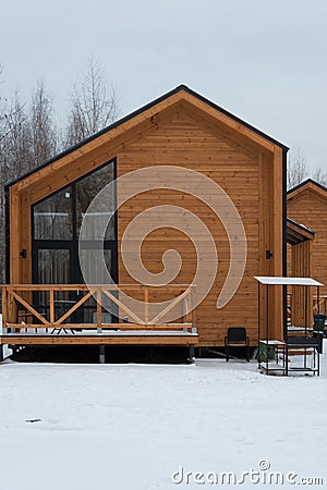 Barnhouse style house. The house is surrounded by snow. Winter and frost. Architectural style Stock Photo