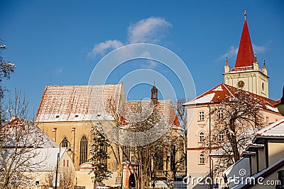 Baroque bell tower called Blatenska vez, Medieval Gothic Church of the Assumption of the Virgin Mary, snow in winter sunny day, Editorial Stock Photo