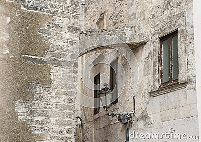 Baroque lamp narrow street, City of Ostuni, Apulia, Italy. Editorial Stock Photo