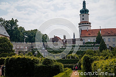 Baroque romantic castle Nove mesto nad Metuji with park, renaissance chateau, round white clock tower, red tile roof, Italian Editorial Stock Photo