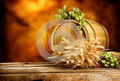 Barrel of beer with hop cones and ears wheat on vintage wooden table Stock Photo