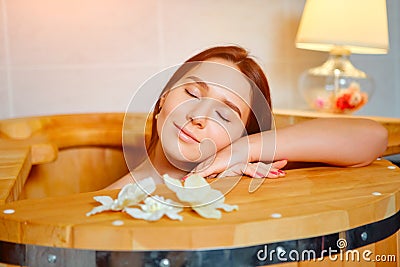 Barrel cedar. Wellness spa sauna. Aromatherapy treatment. Young beauty woman. Girl face Stock Photo