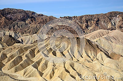 Vast, colorful, barren, desert landscape of rugged mountains and sharp, steep ridges Stock Photo