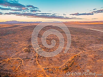 Barren desert land and hills in the distance. Stock Photo