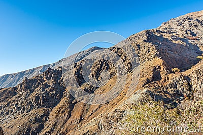 Barren mountain in Darband valley in autumn in the morning against blue sky in the Tochal mountain. A popular recreational region Stock Photo