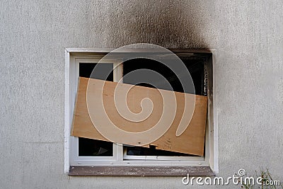 Barricaded window after the fire damage in an apartment house, concept for arson, negligence and insurance Stock Photo