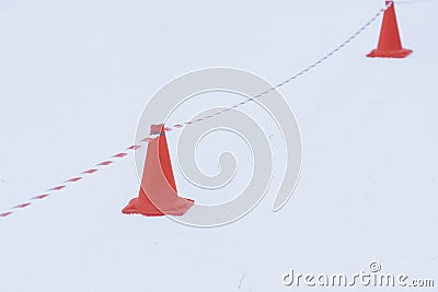 Barrier cones and tape. Winter roadblock. Danger, traffic cone. Stock Photo
