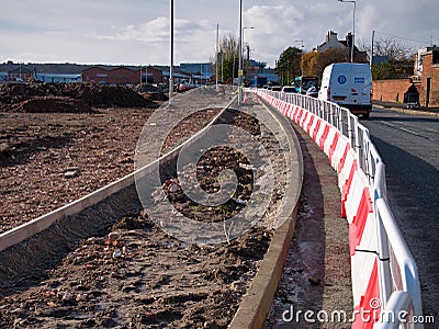 Barriers section off the area in which a new cycle lane / pedestrian walkway is being built Editorial Stock Photo