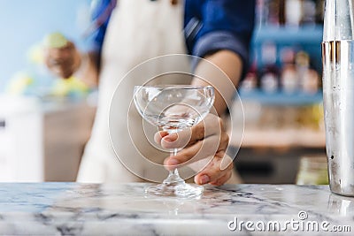 Bartender gently grab a wine glass for making cocktail Stock Photo