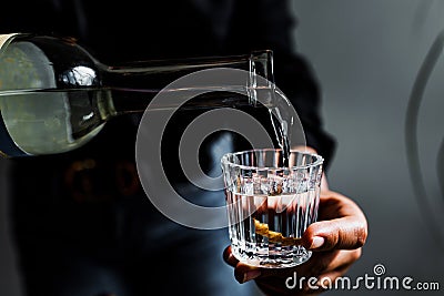 Barman hand serving mexican mezcal shot drink in a traditional glass in Mexico city Stock Photo
