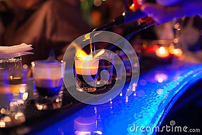 The bartender makes hot alcoholic cocktail and ignites bar. elite night club during party prepares a fiery cocktail Stock Photo