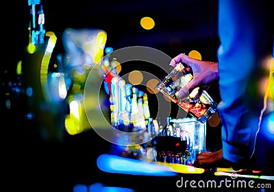 Bartender making alcohol cocktail at bar counter at nightclub, barman is making cocktail Stock Photo