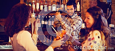 Bartender mixing a cocktail drink in cocktail shaker Stock Photo