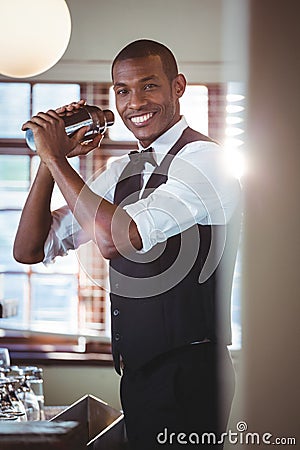 Bartender mixing a cocktail drink in cocktail shaker Stock Photo