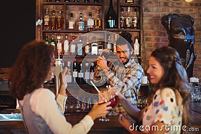 Bartender mixing a cocktail drink in cocktail shaker Stock Photo