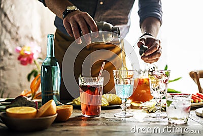 Bartender mixing colorful cocktails Stock Photo