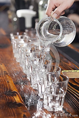 Bartender pouring glasses Stock Photo