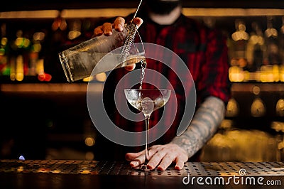 Bartender pourring a Twinkle achoholic cocktail drink from the m Stock Photo