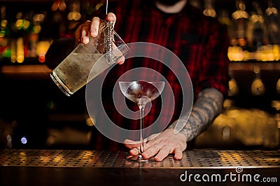 Bartender pourring a Twinkle achoholic drink from the measuring Stock Photo