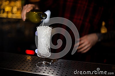 Bartender pourring a white achoholic drink from the bottle Stock Photo