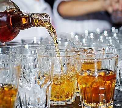 Bartender pours whiskey Stock Photo