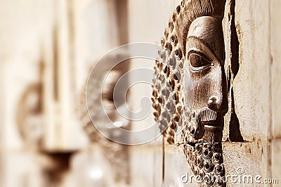 Bas-relief carved on the walls of old buildings in Persepolis. Selective focus. Persepolis is the capital of the ancient Achaemeni Stock Photo