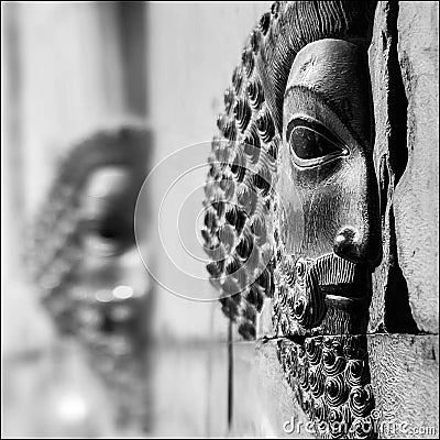 Bas-relief carved on the walls of old buildings in Persepolis. Selective focus. Stock Photo