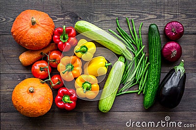 Base of healthy diet. Vegetables pumpkin, paprika, tomatoes, carrot, zucchini, eggplant on dark wooden background top Stock Photo